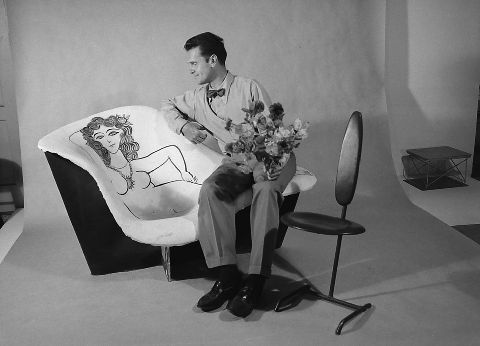 Charles Eames &quot;flirting&quot; with La Chaise he designed and decorated, 1960