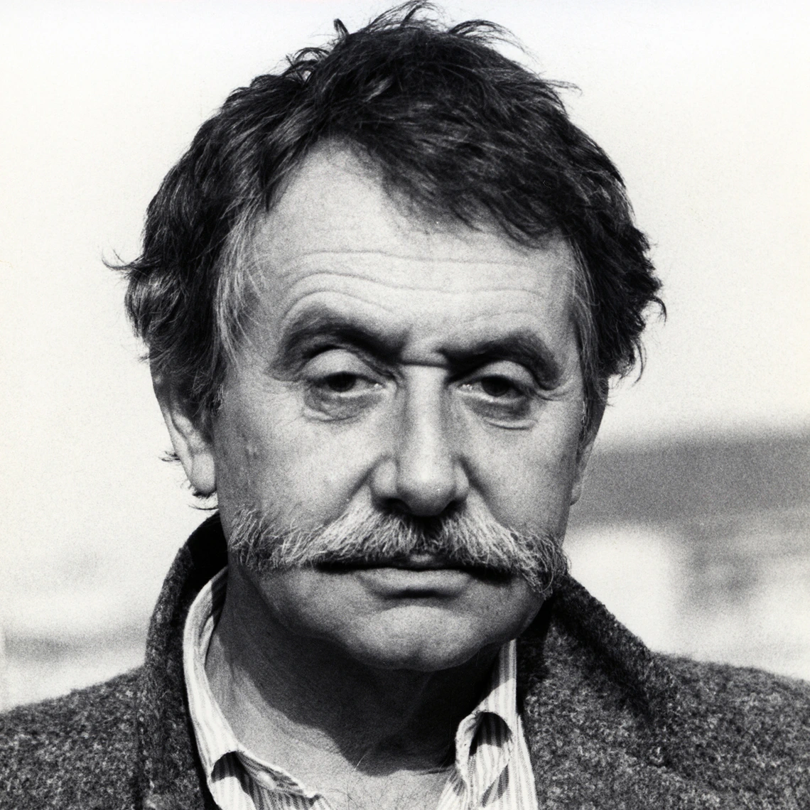 Ettore Sottsass wearing moustache, looking downwards