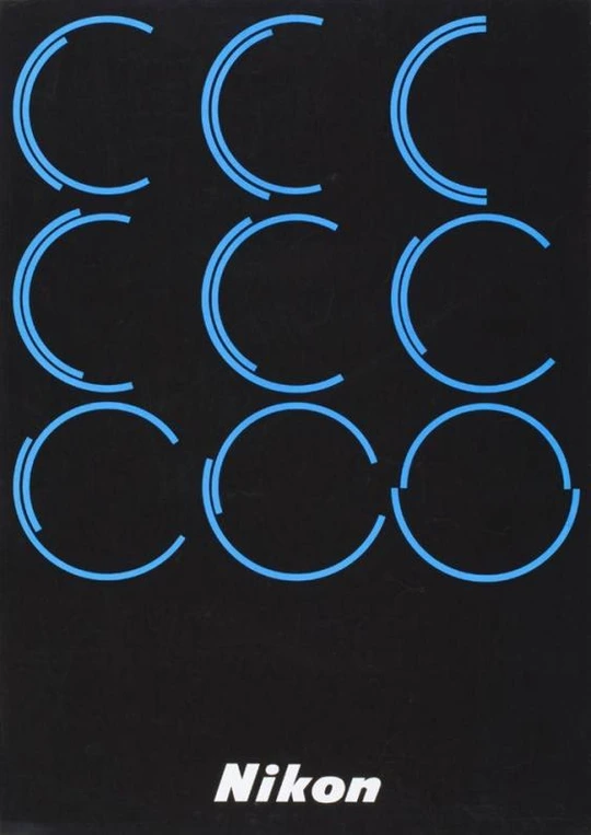 Poster for Nikon. Nine blue circles and a word Nikon on a black background