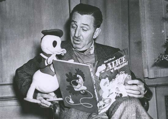 Walt Disney with Donald Duck puppet reading Alice in Wonderland