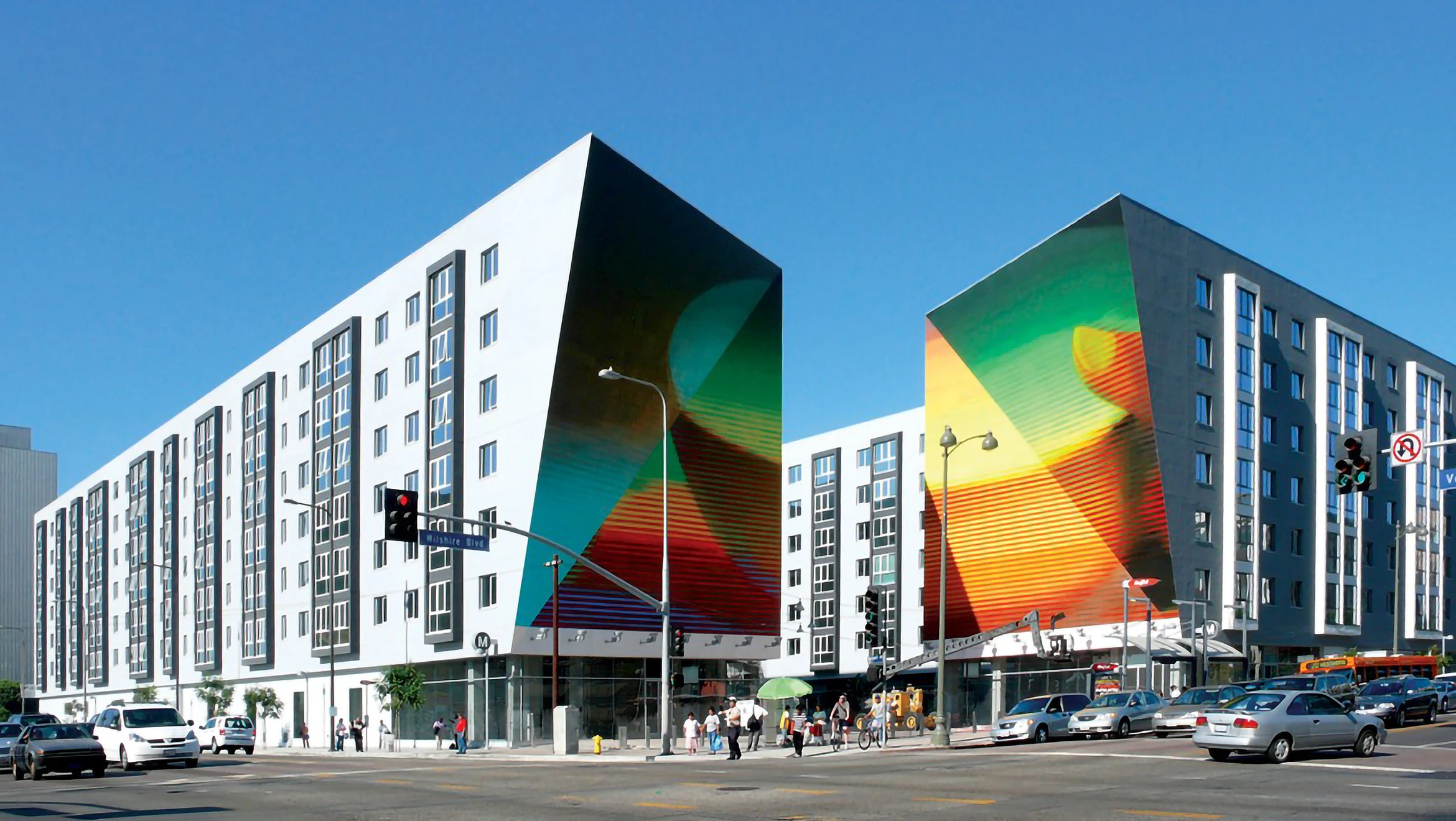 Two pictures on neighboring houses  combining to form an image of a hand with a bowl