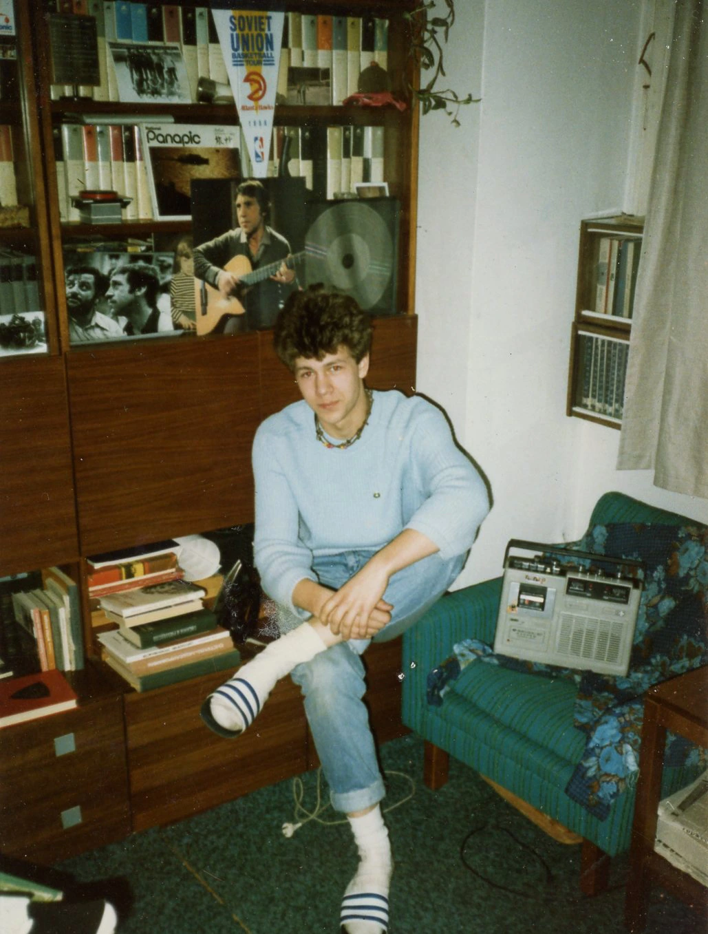 Anton Ioukhnovets sitting in front of a cupboard