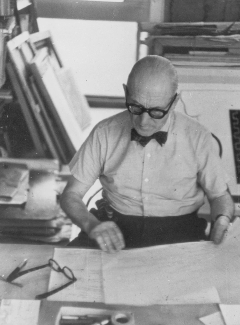 Le Corbusier at his desk