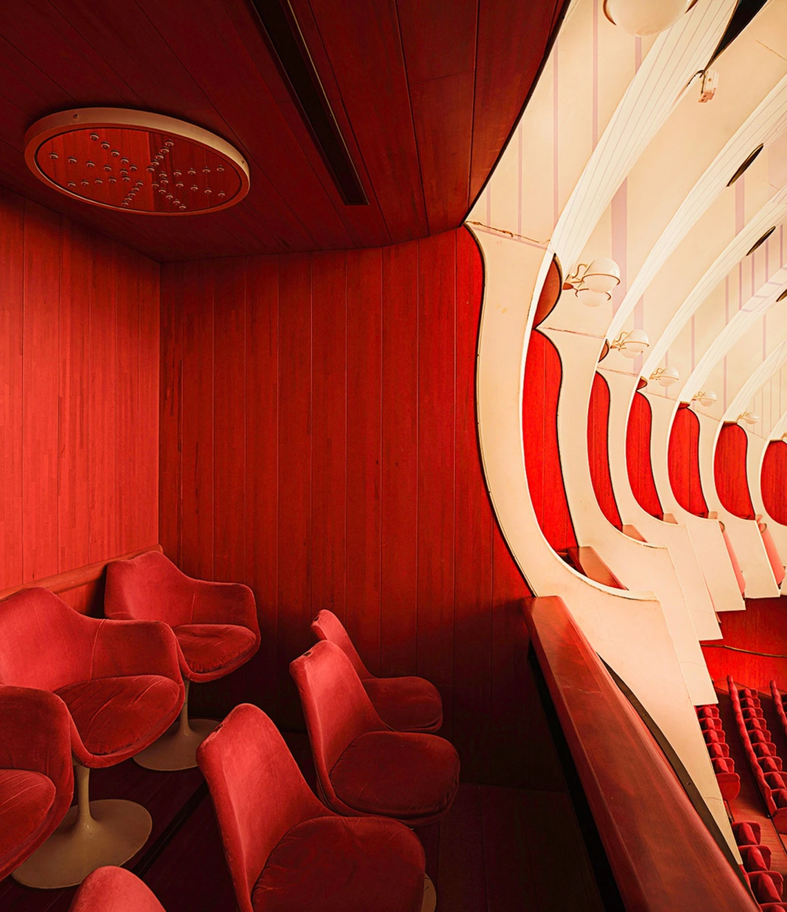 A closeup of Mollino-designed chairs in his Teatro Regio. A red theater lodge