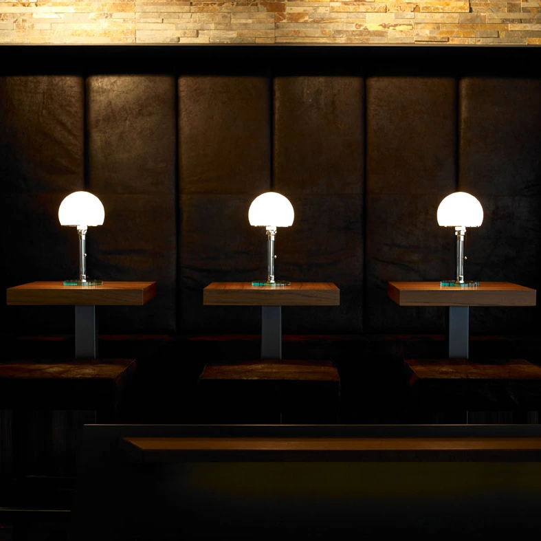WG 24 table lamps designed by Wilhelm Wagenfeld. Three table lamps in a leather interior