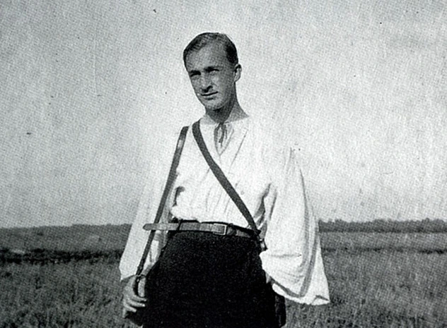 Young Alexey Brodovitch in a white shirt and a black trousers looking into camera