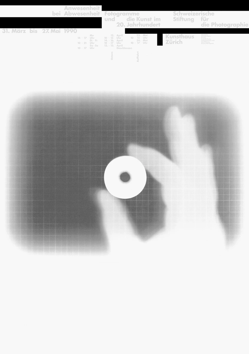 A poster with a silhouette of a hand holding a white circle with a hole in it