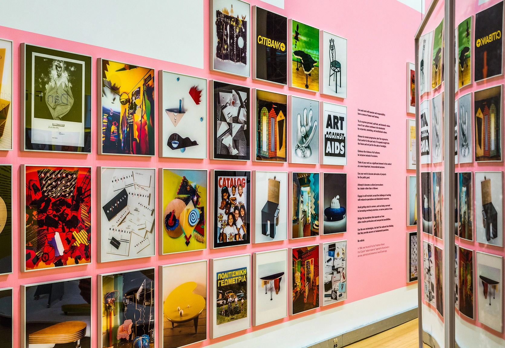 Installation view of Dan Friedman: Radical Modernist exhibition. A pink wall with some posters