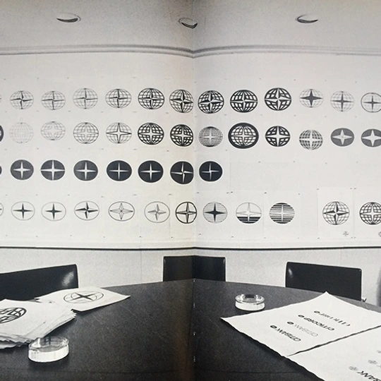 Black and white logo sketches on a white wall