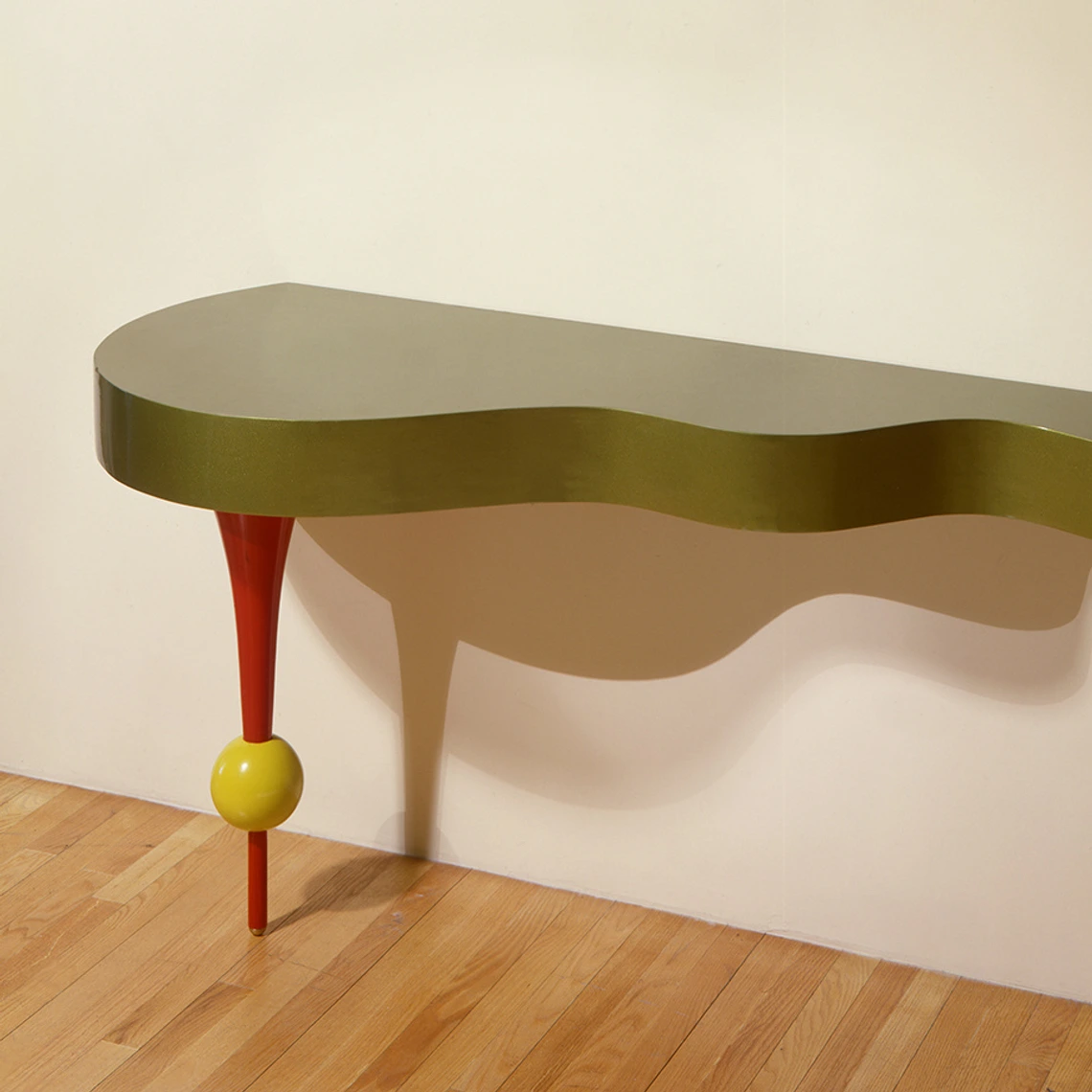 Side Table. A half of a table attached to the wall