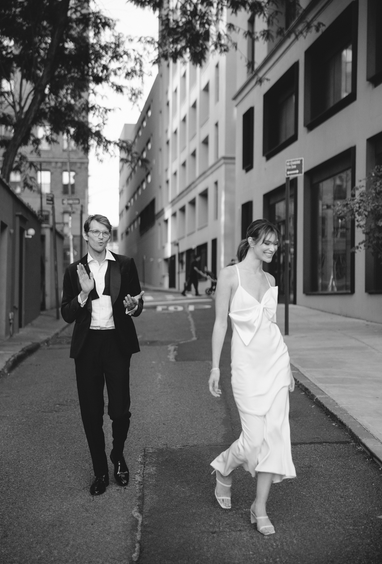Bride and groom laughing at a private joke during their portraits at a historic downtown LA hotel. Los Angeles Wedding photography.