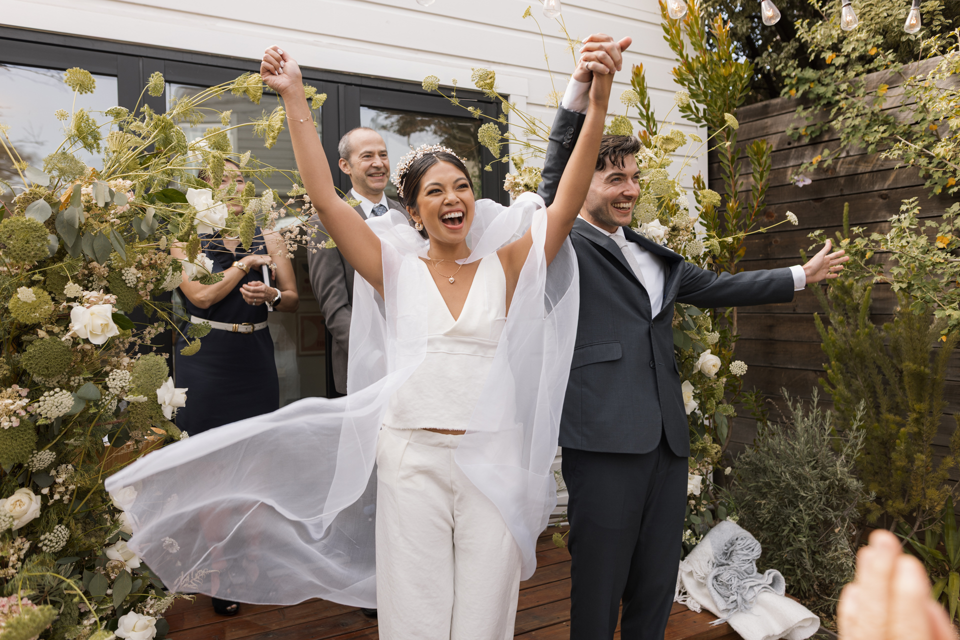 Joyful, candid moment between the bride and groom, captured during their wedding ceremony at a historic home in San Francisco.