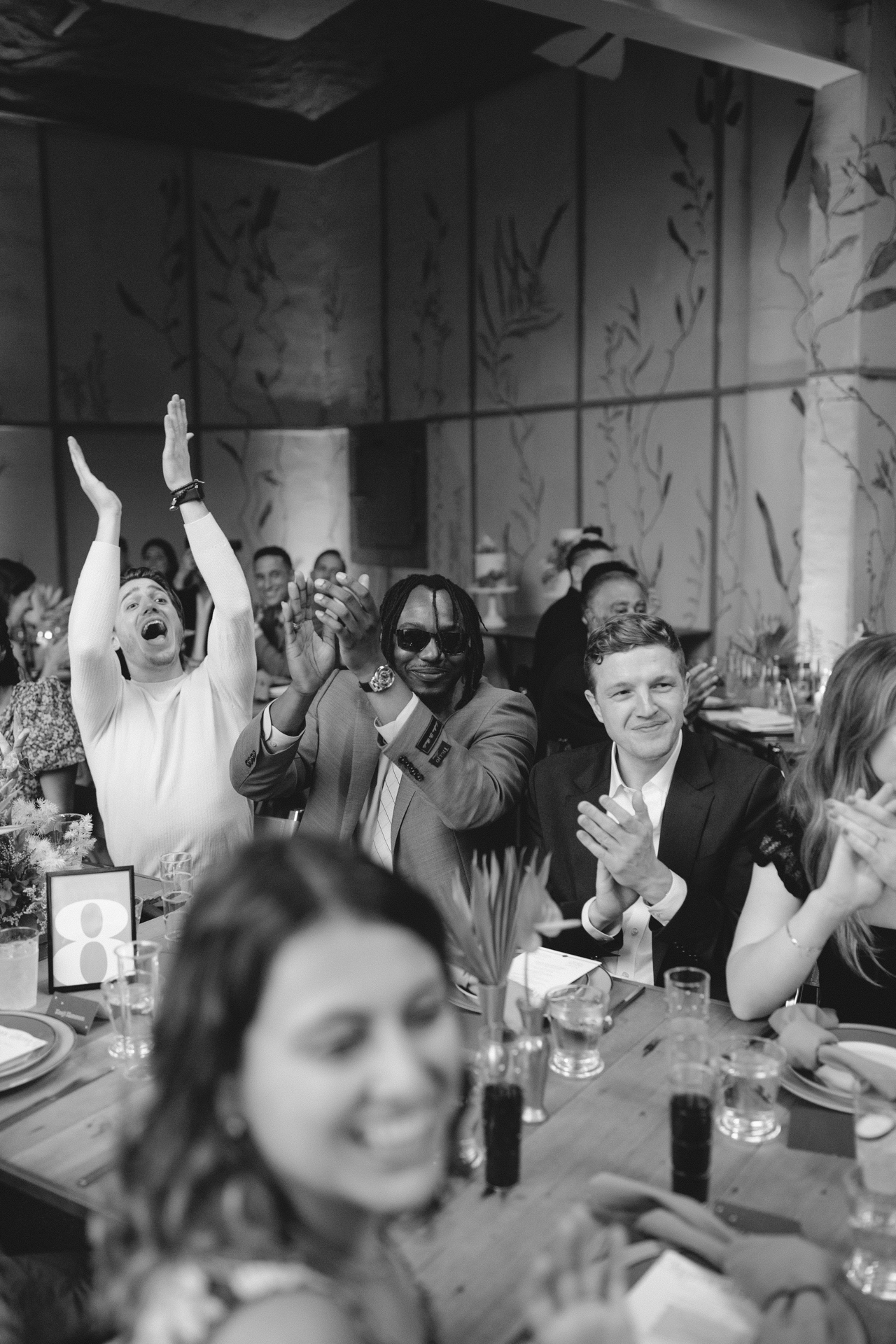 Cheering diverse wedding guests during a wedding reception at a chic wedding venue in Ojai, California. Ojai Wedding Photography.