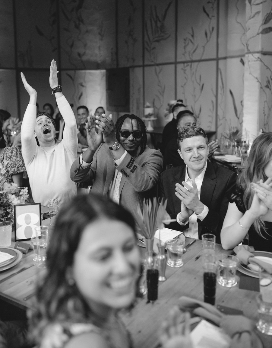 Cheering diverse wedding guests during a wedding reception at a chic wedding venue in Ojai, California. Ojai Wedding Photography.