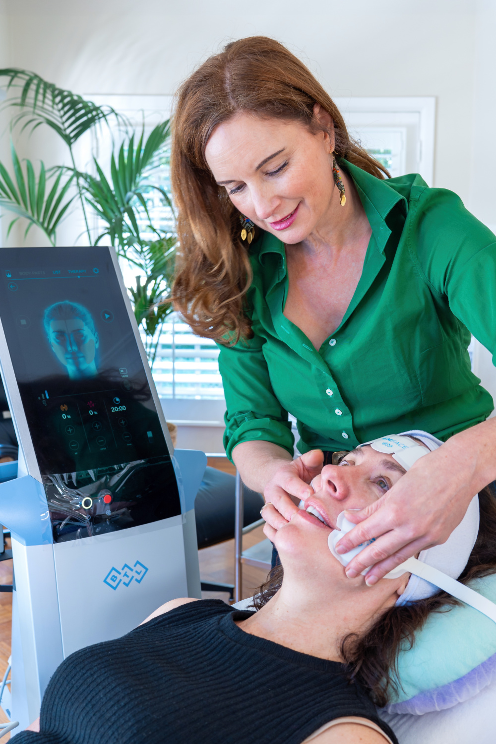 Dr Lizzy treating a patient with the Emface machine