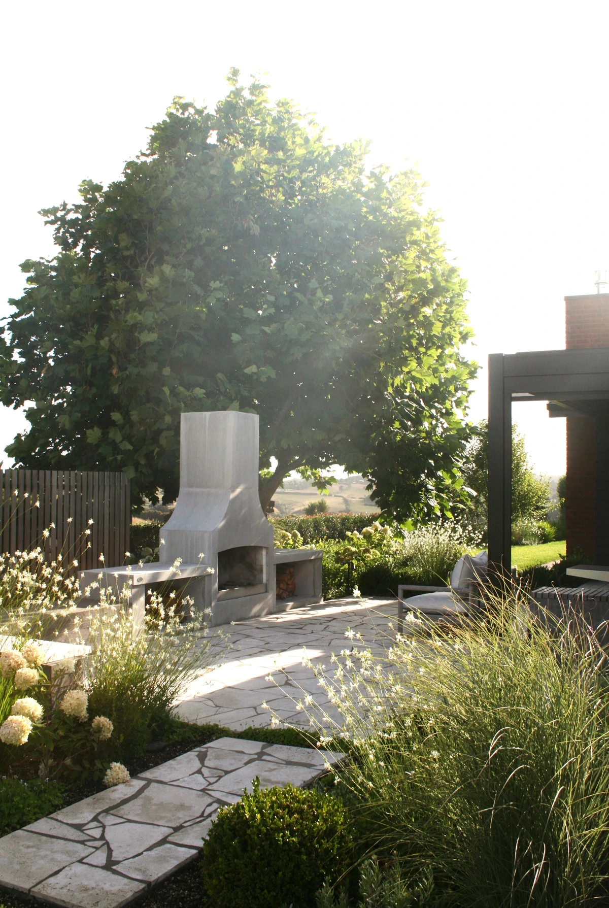 Pukekohe: stone paving through grasses in a family garden, south Auckland