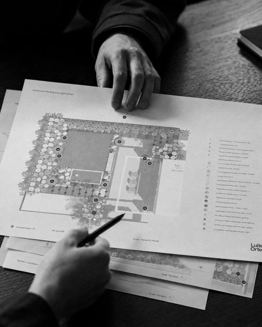 Hand-drawing over a printed landscape masterplan in the studio