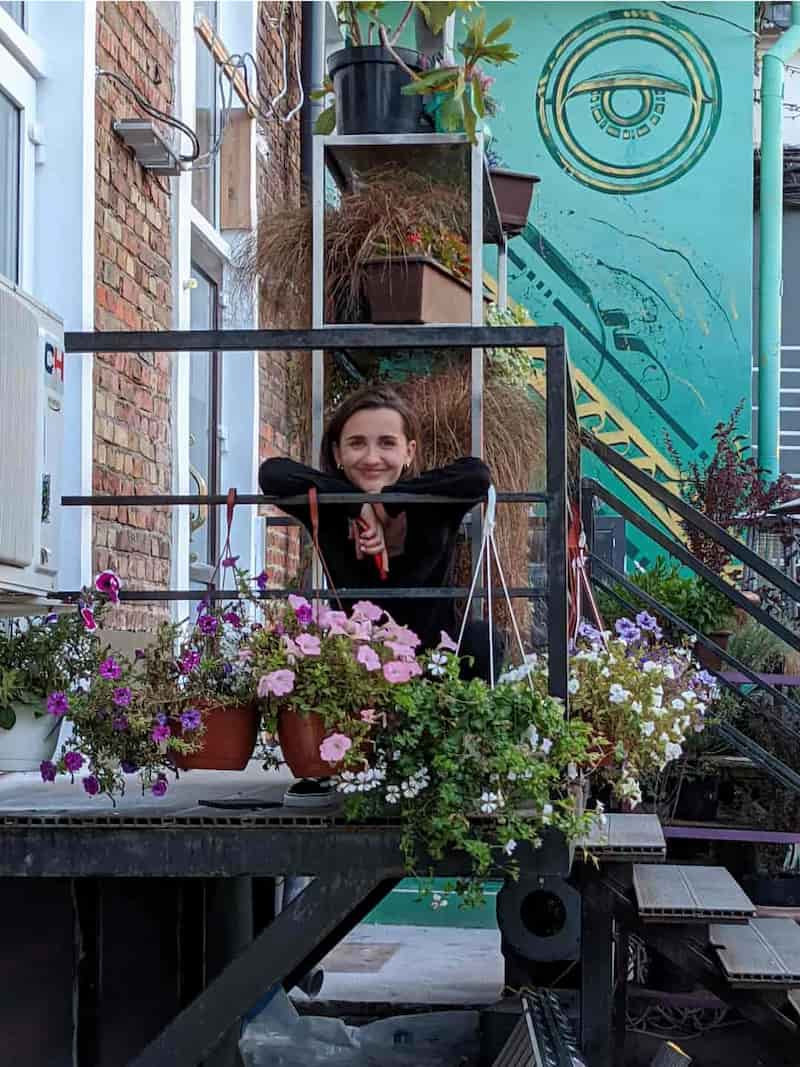 This is Nastya, a strong 69pixels studio designer, posing for a cameraman standing in flowers