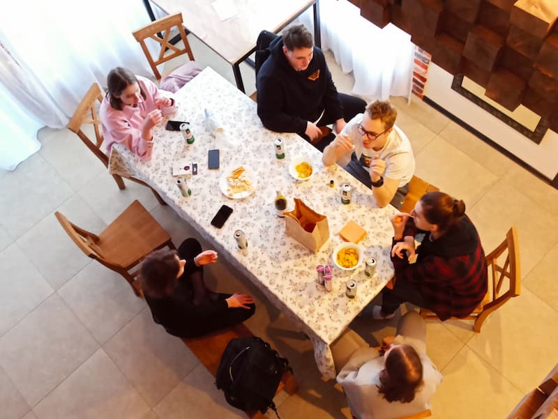 The 69pixels team is sitting at the table and discussing business at the winter corporate party in 2021