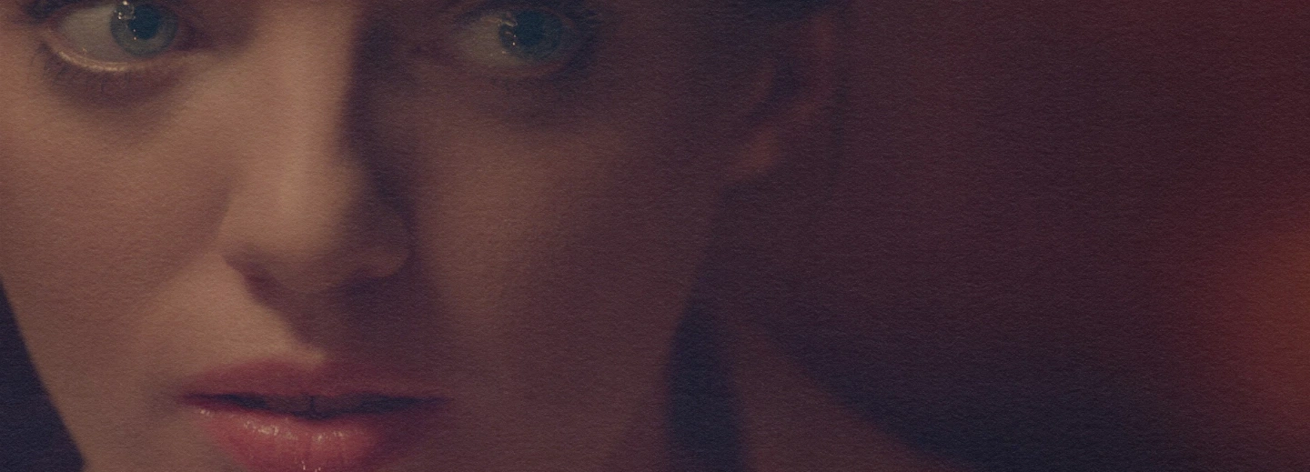 A tight, shallow-depth-of-field close-up from the film 'Cella,' highlighting the emotional expression and striking green eyes of the lead actress.
