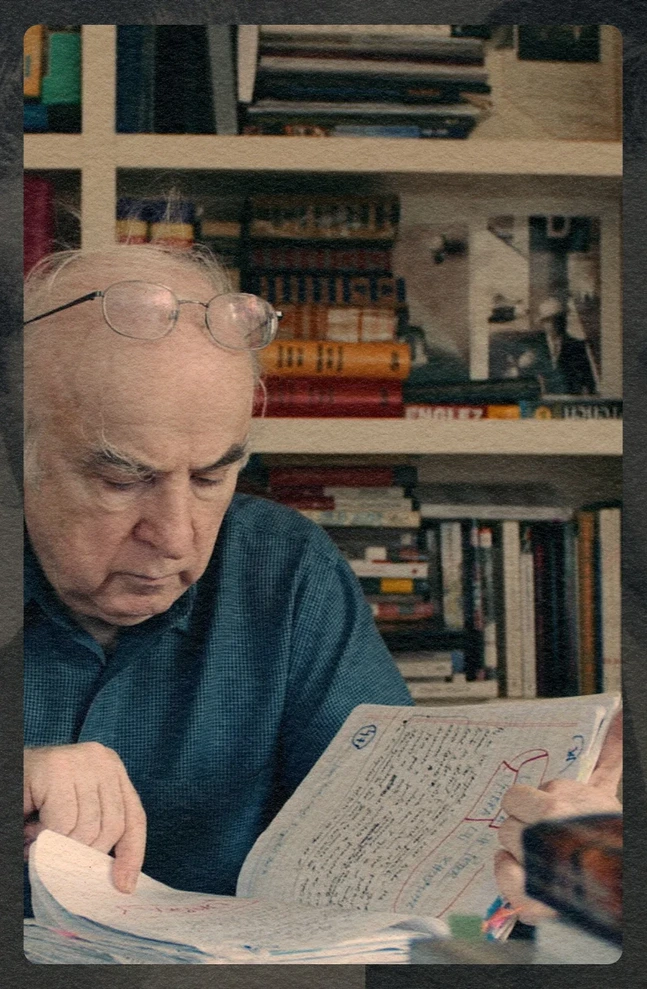 A medium close-up of author Norman Manea reviewing handwritten notes for a novel, from a creative film project for Yale University Press.