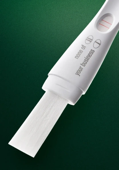 Toronto conceptual still life photography of a pregnancy test on a green backdrop.