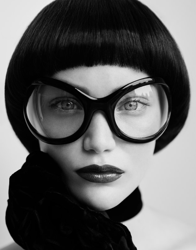 M. Milenio — black-and-white fashion portrait with oversized sunglasses, photographed by Kourosh Sotoodeh.