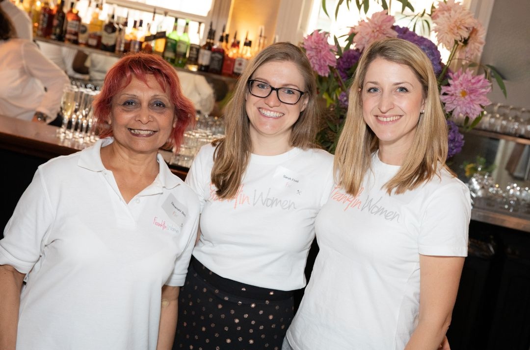 Three members of the Franklin Women team standing together at an event in 2019, wearing Franklin Women shirts.