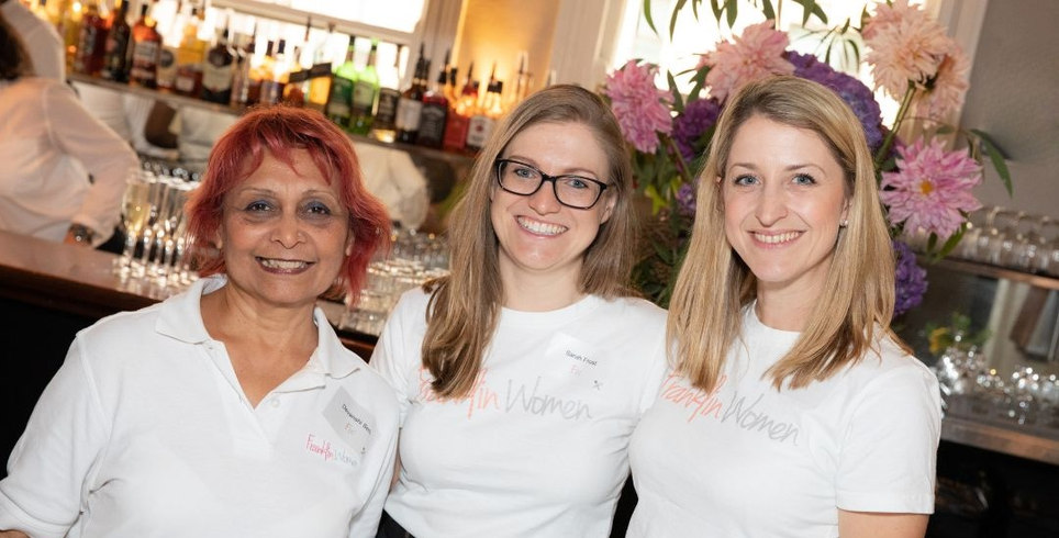 Three members of the Franklin Women team standing together at an event in 2019, wearing Franklin Women shirts.